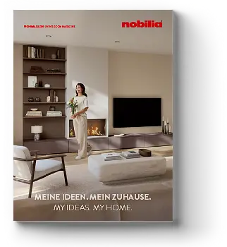 Woman in a modern living room arranging items on a shelving unit beside a flat-screen TV, with text overlay: "MEINE IDEEN. MEIN ZUHAUSE. MY IDEAS. MY HOME."