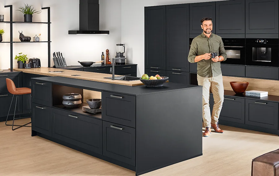 Modern kitchen in black with elegant island, open shelves and framed fronts in a homely atmosphere.