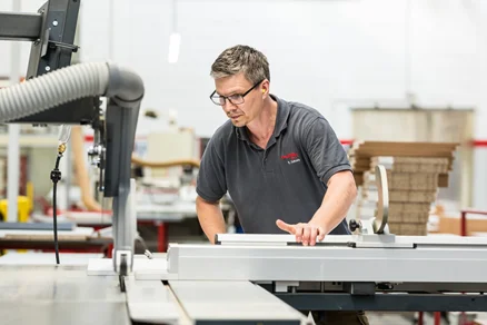 Tischler bei der präzisen Holzverarbeitung in der Produktion – handwerklicher Job mit Zukunft bei nobilia.
