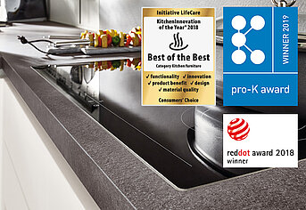 Modern kitchen featuring a sleek undermount sink with awards for innovation and design, including the "KitchenInnovation of 2018" and "Red Dot Award 2018".