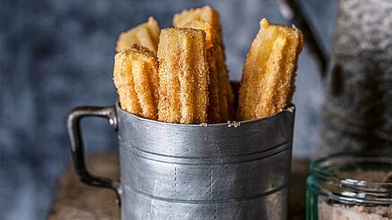 Knusprige Churros: Das wissen auch die Spanier und Mexikaner, bei denen die frittierten Teigstangen regelmäßig auf dem Esstisch landen. Das knusprige, süße Gebäck kannst Du allerdings auch ganz einfach in der heimischen Küche zubereiten!