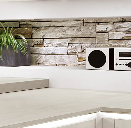 Ce plan de travail clair avec le numéro de décor **353** en **imitation béton blanc** convient parfaitement aux concepts de cuisine modernes. Son aspect béton discret confère à la cuisine une légèreté urbaine et se combine parfaitement avec des façades claires et des matériaux naturels - parfait par exemple pour la cuisine présentée avec la façade Riva 891. Il apporte de la clarté et du calme dans la pièce et crée une atmosphère conviviale.