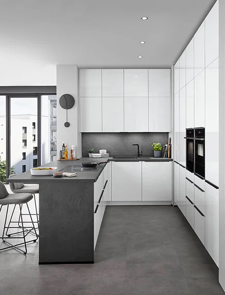 Modern kitchen with Novalux 516 front in high-gloss white, elegant cooking island in stone look, relaxed living atmosphere with dining area and dog in the foreground.