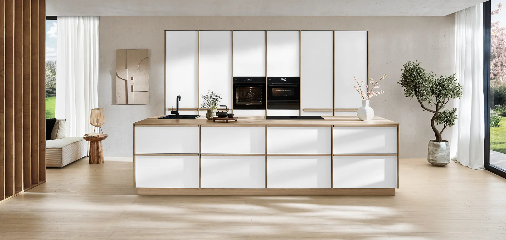 Sakura design line in Japandi style: clear lines, light-colored fronts and warm wood accents for a harmonious living experience.