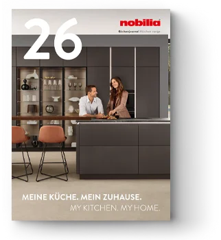 A modern kitchen design with sleek black cabinets, open shelving, and a central island, featuring a person happily cooking, from Nobilia's collection.