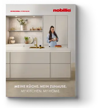 A modern kitchen design with sleek black cabinets, open shelving, and a central island, featuring a person happily cooking, from Nobilia's collection.