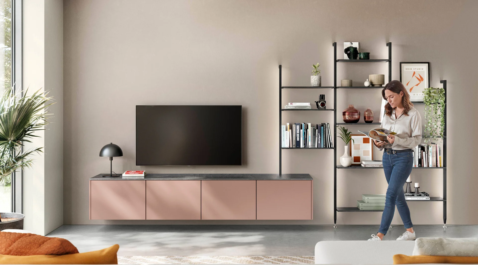 Wohnzimmer in Koralle mit beleuchtetem Stollenregalsystem, TV-Möbel und offenem Regal im Wohnbereich.