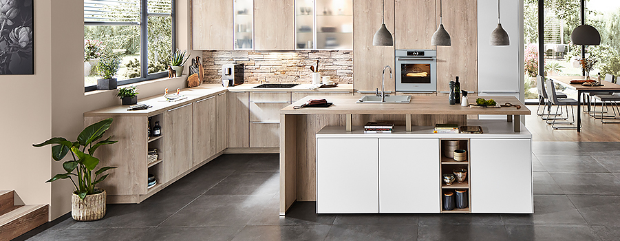 Modern kitchen design featuring clean lines, wood accents, state-of-the-art appliances, and a central island with open shelving in a bright, spacious interior.