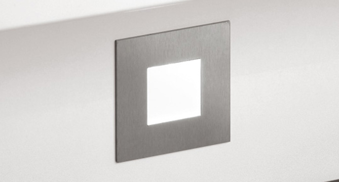 Modern, sleek square wall-mounted light fixture emitting a soft glow, perfect for contemporary interior design and ambient lighting in homes or commercial spaces.