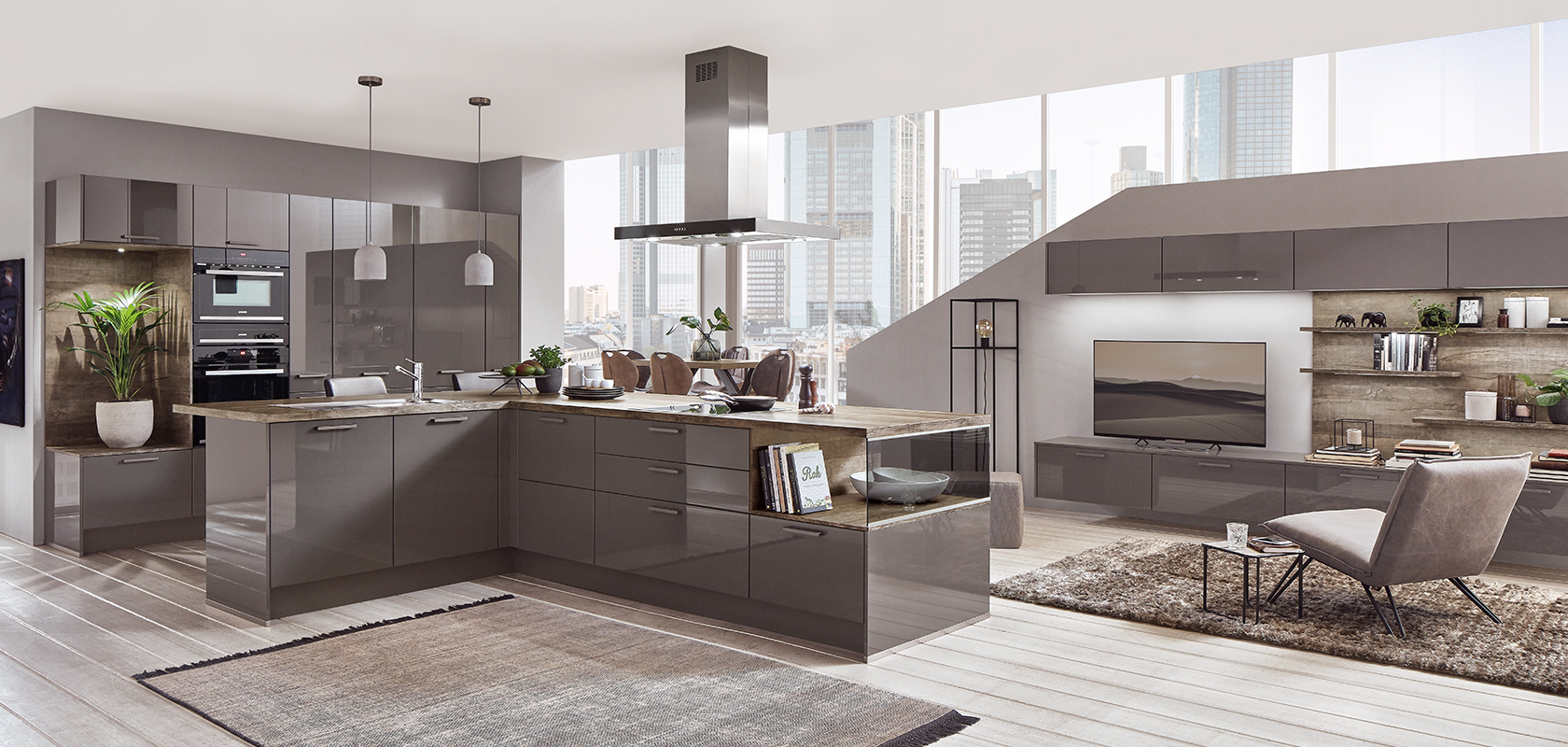 Sleek modern kitchen with integrated appliances and a matching living area, featuring cityscape views through large windows, blending functionality and style.