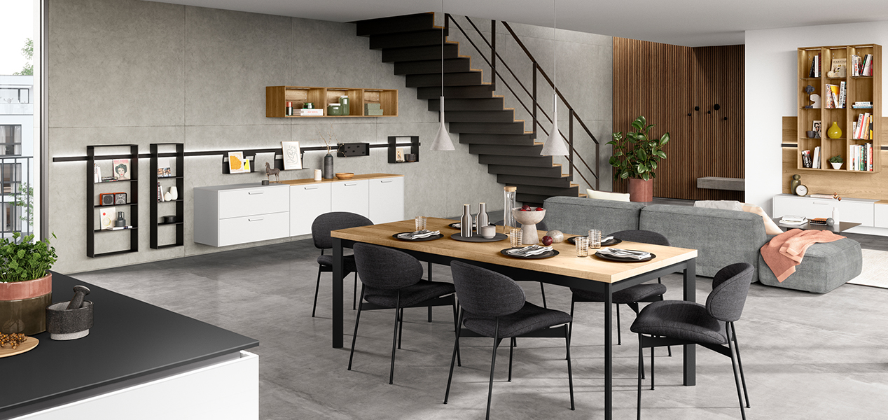 Moderní, prostorná kuchyně s elegantním designem, vybavená jídelním koutem, špičkovými spotřebiči a minimalistickým nábytkem na pozadí neutrálních barev.