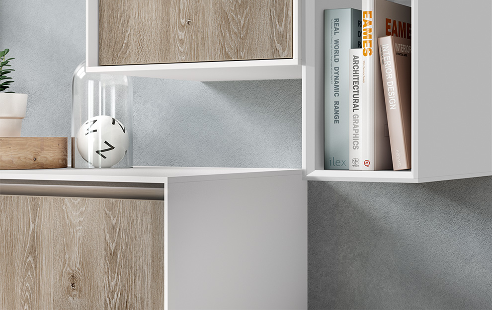 Modern minimalist shelving featuring books on architecture and design, with a decorative plant and clock, against a gray textured wall.