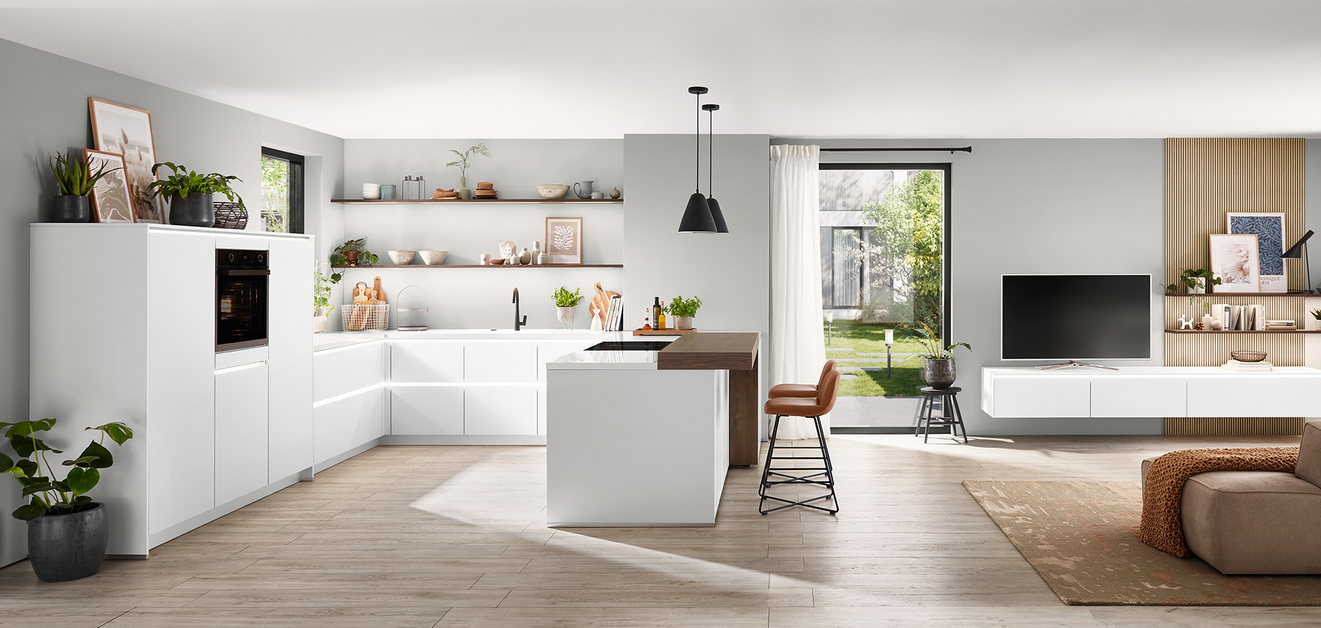 Modern kitchen with white cabinets blends into a chic living space with wood accents, showcasing seamless, contemporary interior design.