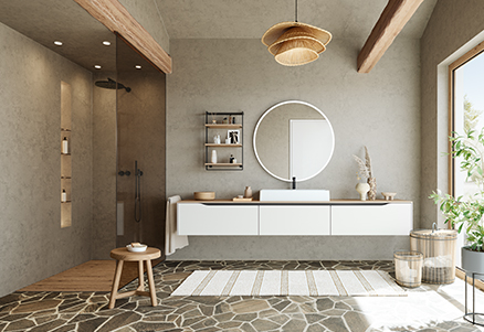 Nowoczesne wnętrze łazienki z wiszącą toaletką, okrągłym lustrem i prysznicem z wejściem bez progów, ozdobione naturalnymi akcentami drewna i ścianami o teksturze, tworzące minimalistyczną estetykę.