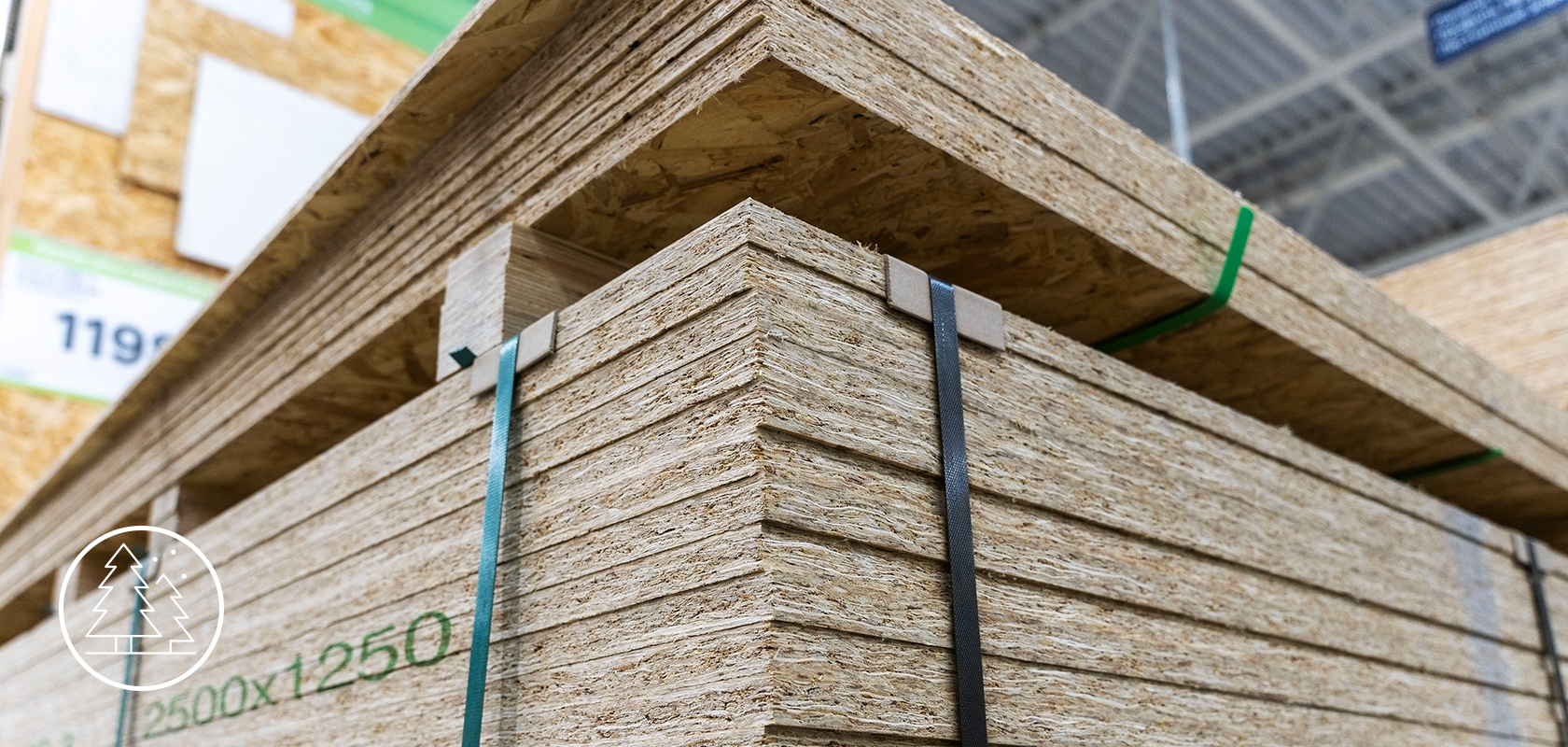 Stacked oriented strand board (OSB) sheets in a warehouse, showcasing their layered construction and dimensions for construction and home improvement projects.