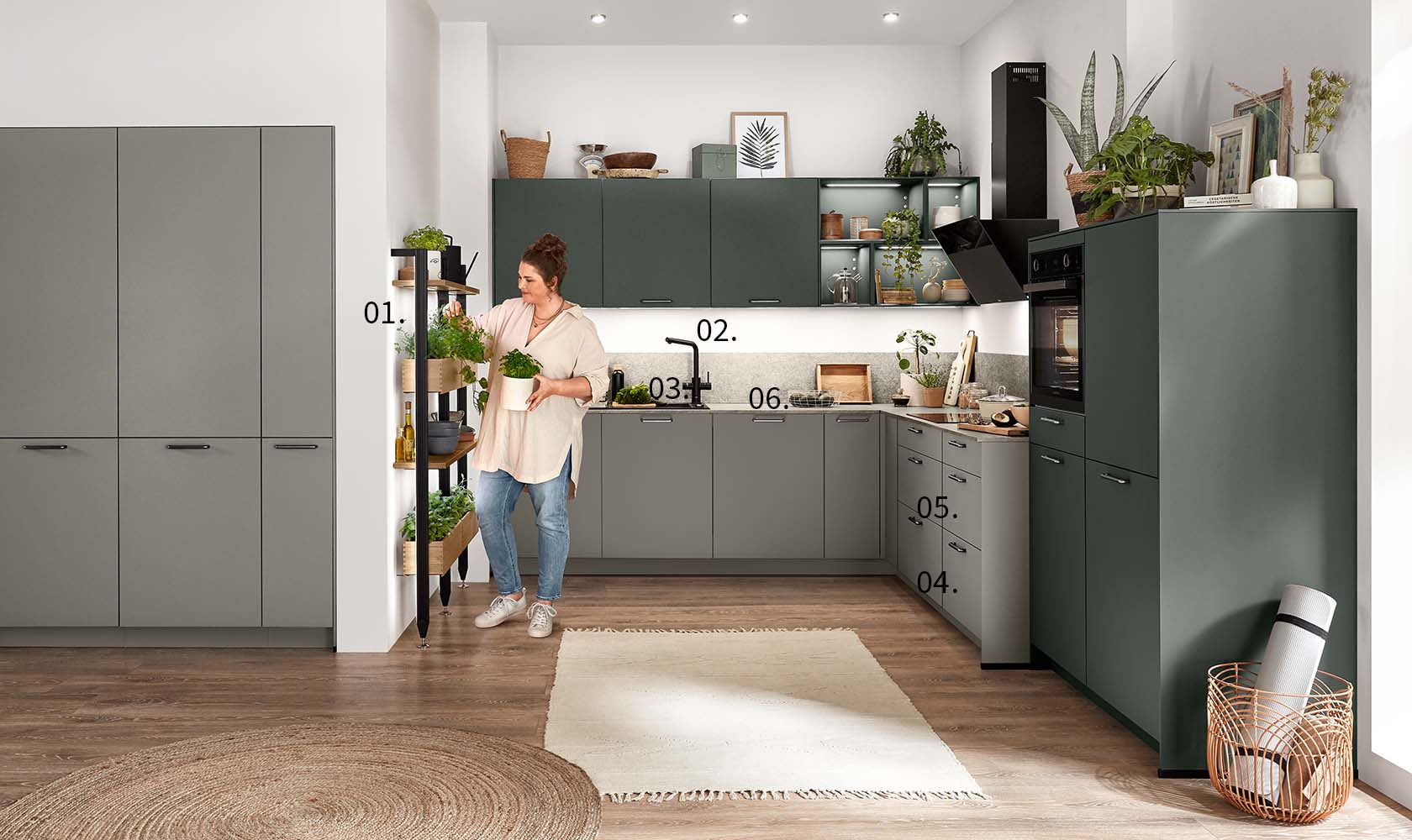 A woman stands in a modern kitchen with numbered pointers highlighting features such as cabinetry, appliances, and decorative plants.