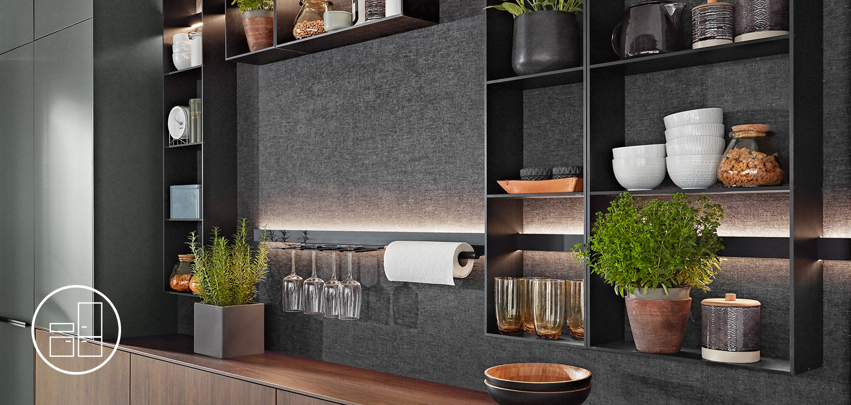 A modern kitchen shelf displaying an array of items including elegant dishware, decorative plants, and neatly placed kitchen towels in a contemporary setting.