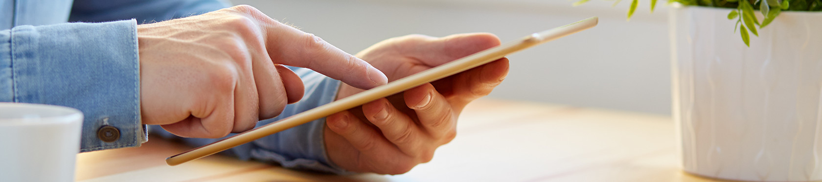 Man reading press reports on a tablet